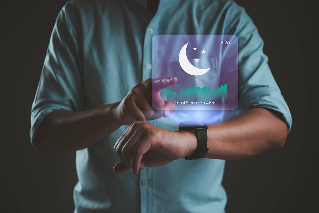 A person using a smartwatch with sleep tracking application for rest cycle and quality analysis.